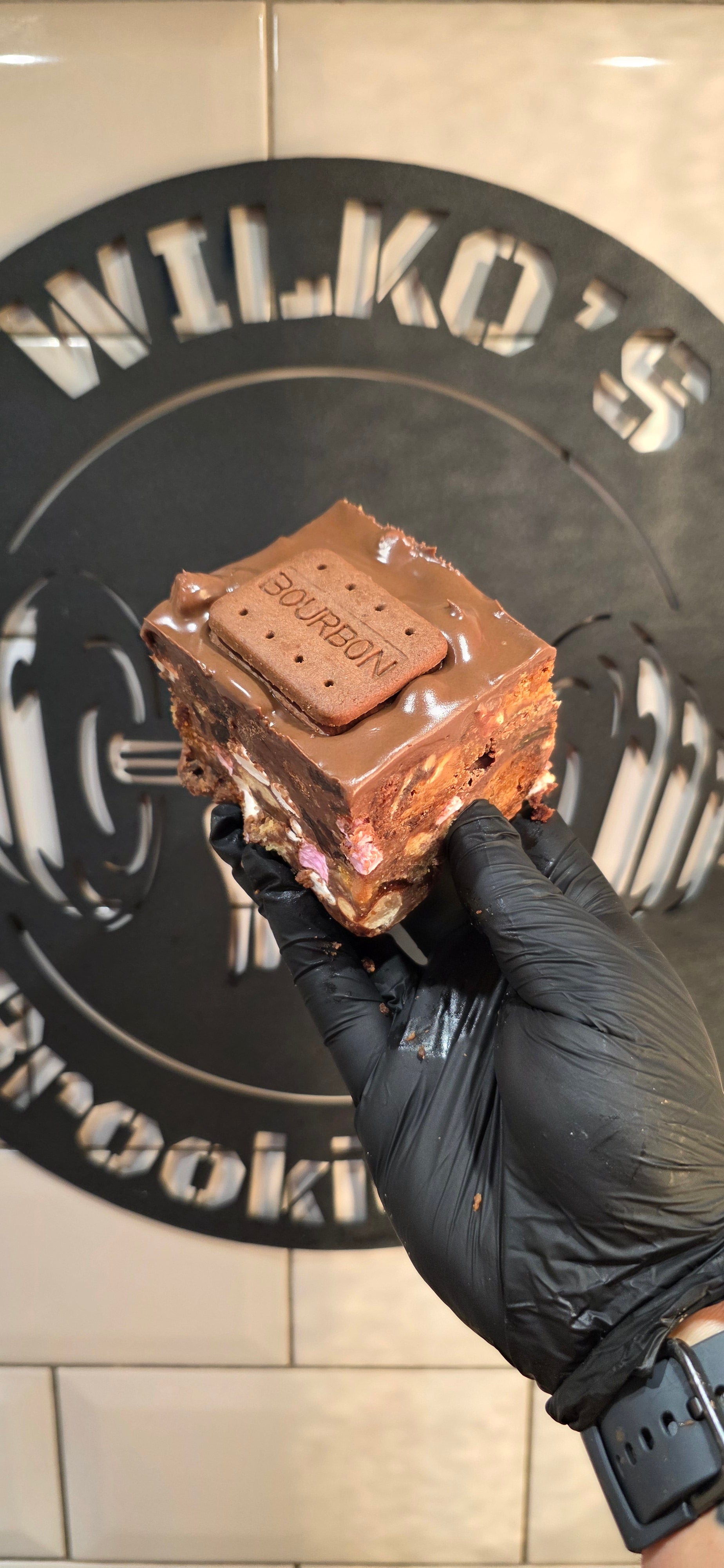 Brookie Road — all our trimmings combined with a classic rocky road mix, finished with chocolate ganache and topped with a Bourbon biscuit